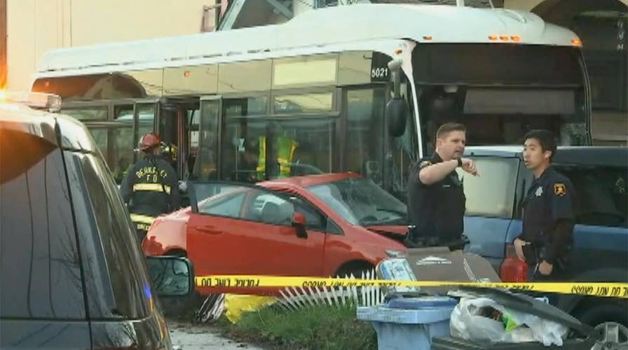 Emergency crews survey damage after bus crashes into homes