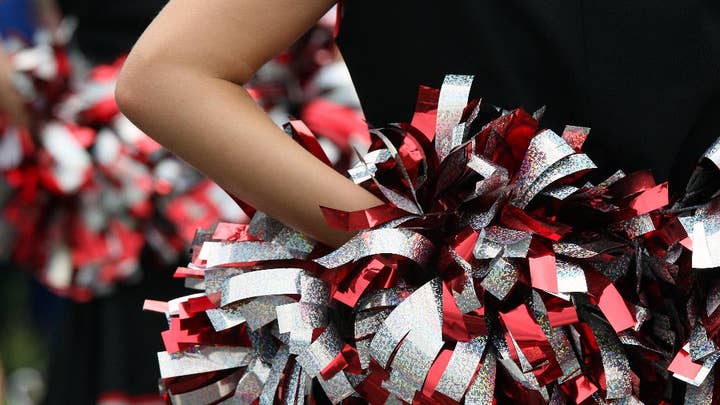 Inspiring: HS cheer squad joins lone cheerleader from opposing school