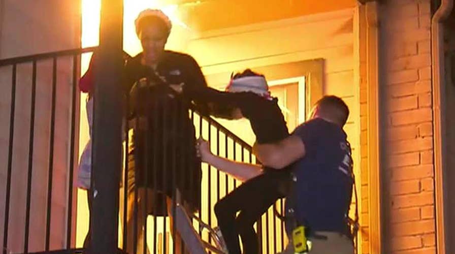 Firefighters rescue family from raging apartment fire