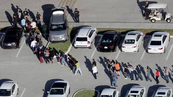 Broward sheriff's deputies took cover behind cars, tree with Parkland shooter believed in school, report says