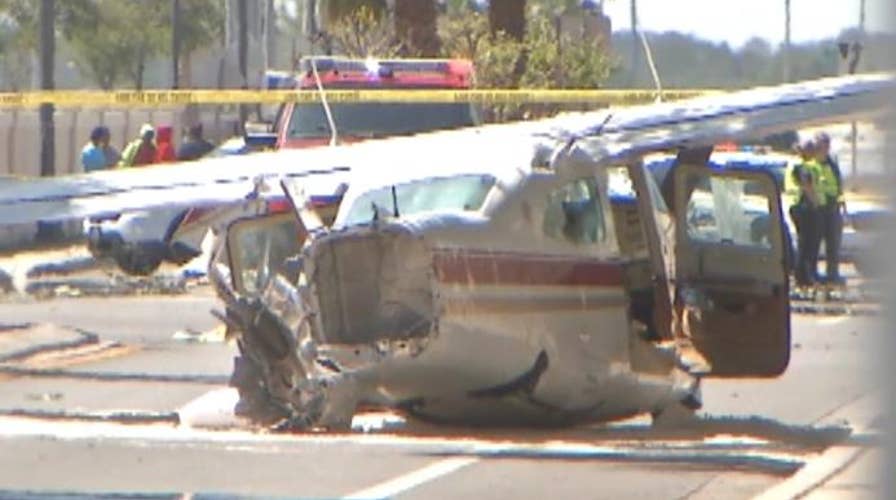 Small plane crashes into street nearly hitting cars