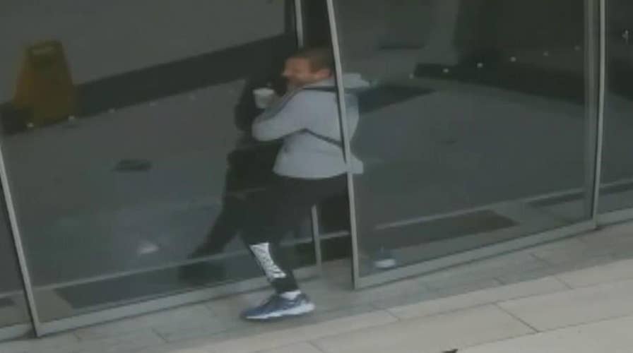Raw video shows burglar getting stuck in sliding door