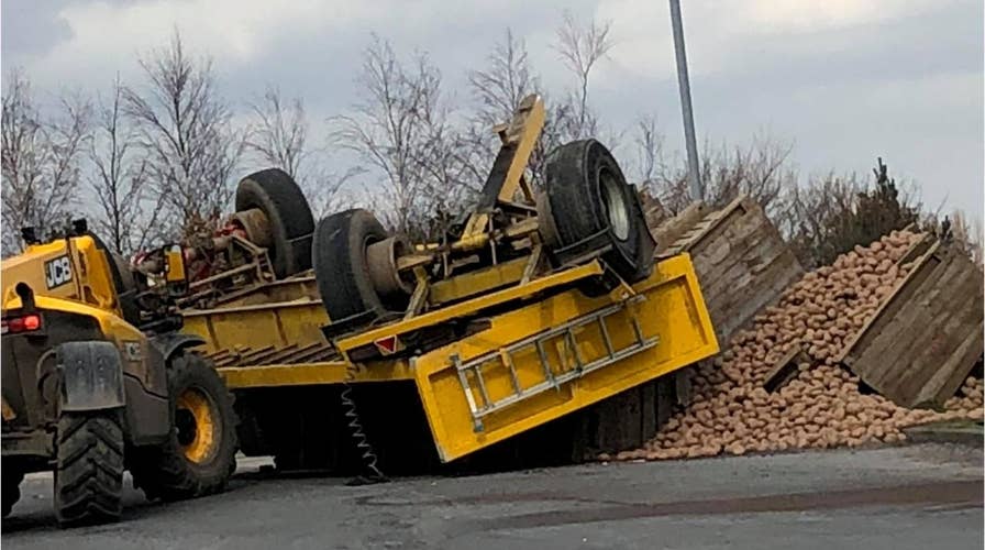 Potato truck topples in traffic circle