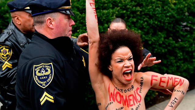 Topless Protester Charges Bill Cosby As He Arrives For Trial Latest