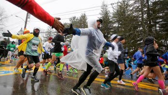 Boston Marathon runners brave strong wind, rain five years after bombing