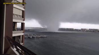 Watch powerful waterspout churn through Florida beach