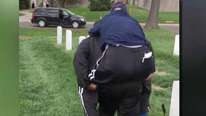 Volunteer carries veteran to see wife's grave