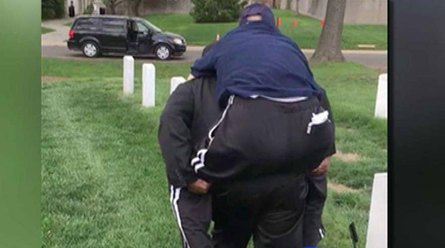 Volunteer carries veteran to see wife's grave