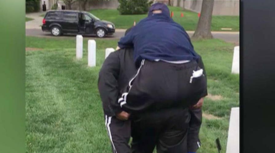 Volunteer carries veteran to see wife's grave