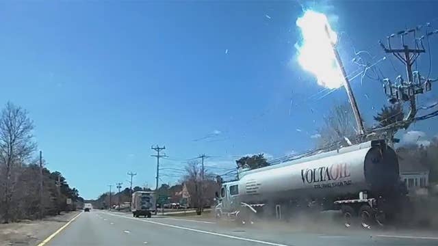 Sparks fly as out-of-control semi crashes into power line