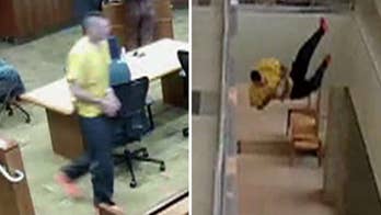 Handcuffed suspect runs out of courtroom, nose dives off 2nd-floor railing in stunning video