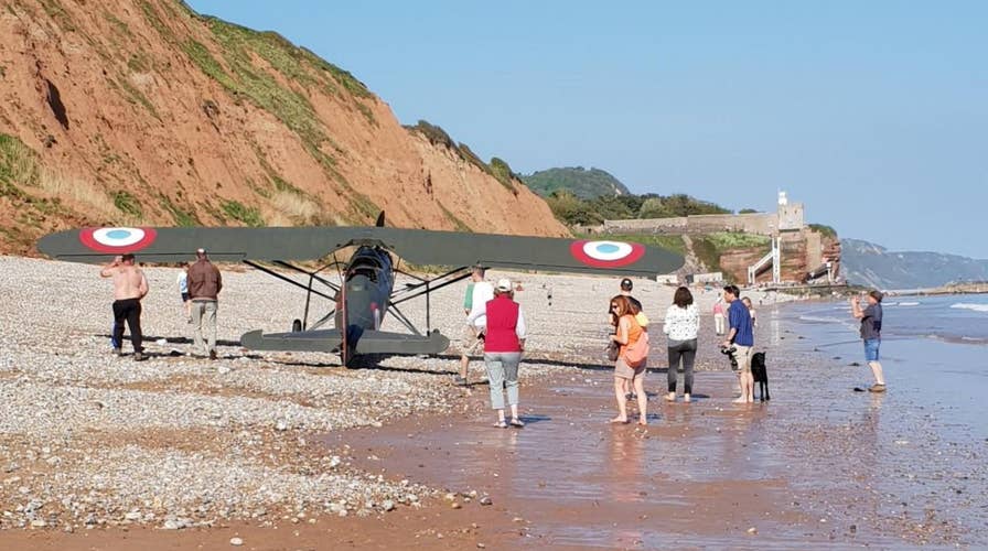 Pilot lands WWI-era plane on crowded beach