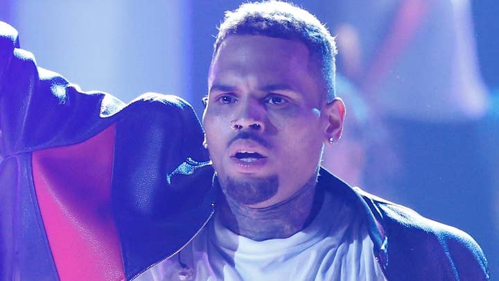 Crowds flock to Chris Brown's California mansion as singer holds yard sale