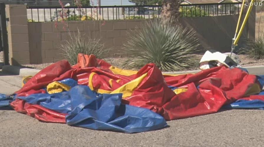 Bounce house blows away with child inside