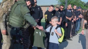 Son of fallen Indiana patrolman greeted by 70 officers in first day back at school