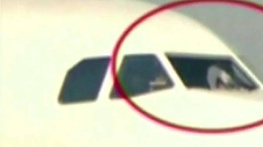 Airline co-pilot partially sucked out window