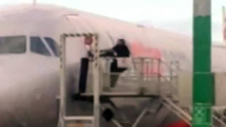 Shocking video: Man tries to pry open airplane door