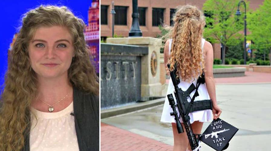 Kent State graduate poses with rifle on campus