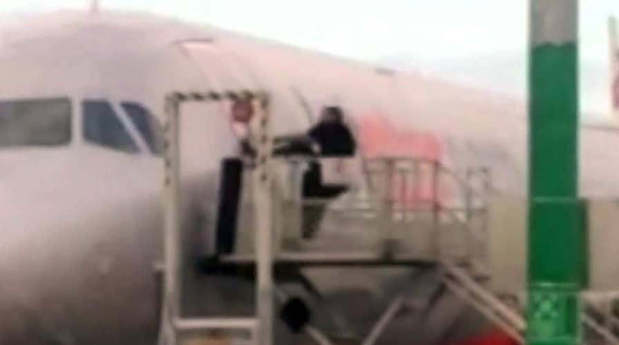 Shocking video: Man tries to pry open airplane door