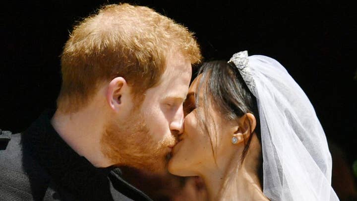 Prince Harry, Meghan Markle kiss for cheering crowds