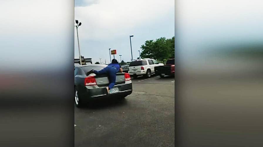 Nail salon worker jumps onto moving car
