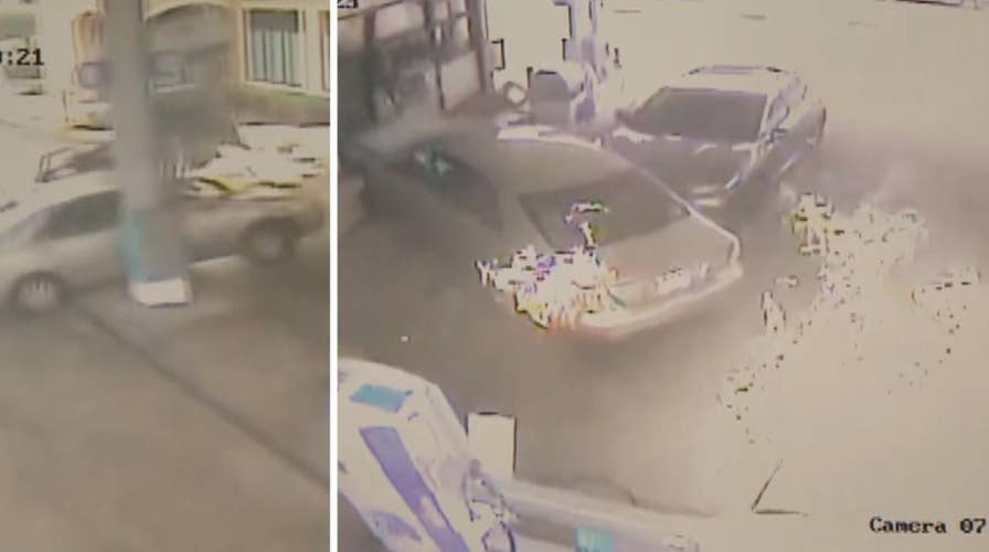 Car slams into gas station, bursts into flames