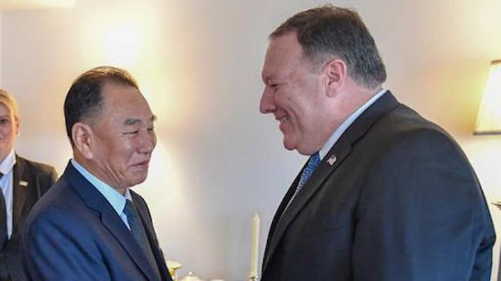 Pompeo shakes hands with Kim Yong Chol