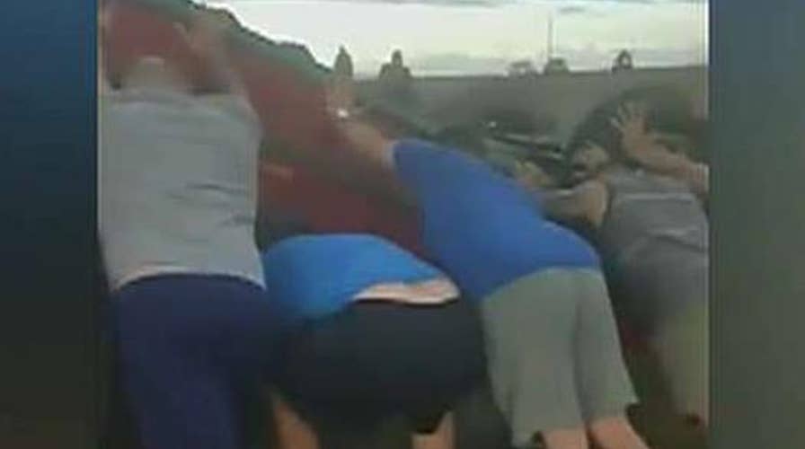 Youth football team lifts car to save woman