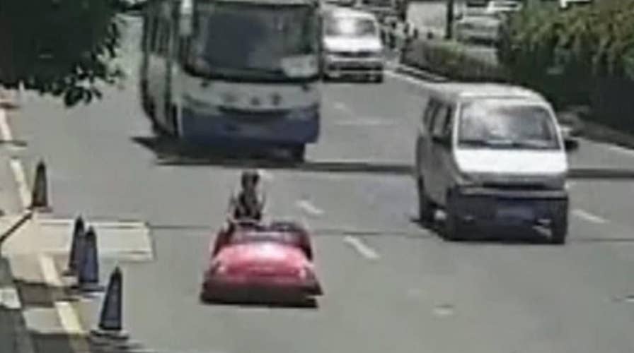 Bumper car driver pulled over by police on busy China street