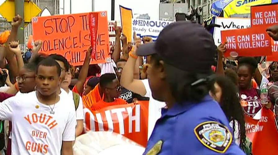 Thousands take to streets to rally against gun violence