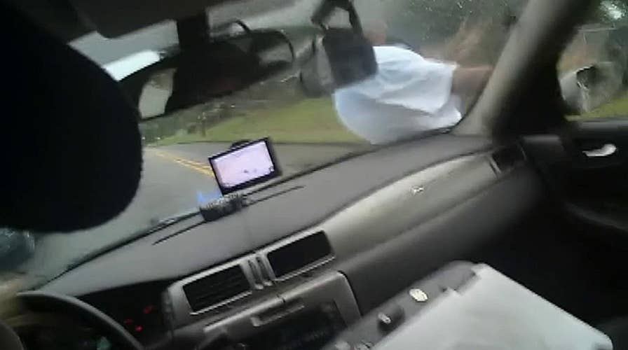 Police officer uses patrol car in suspect take down