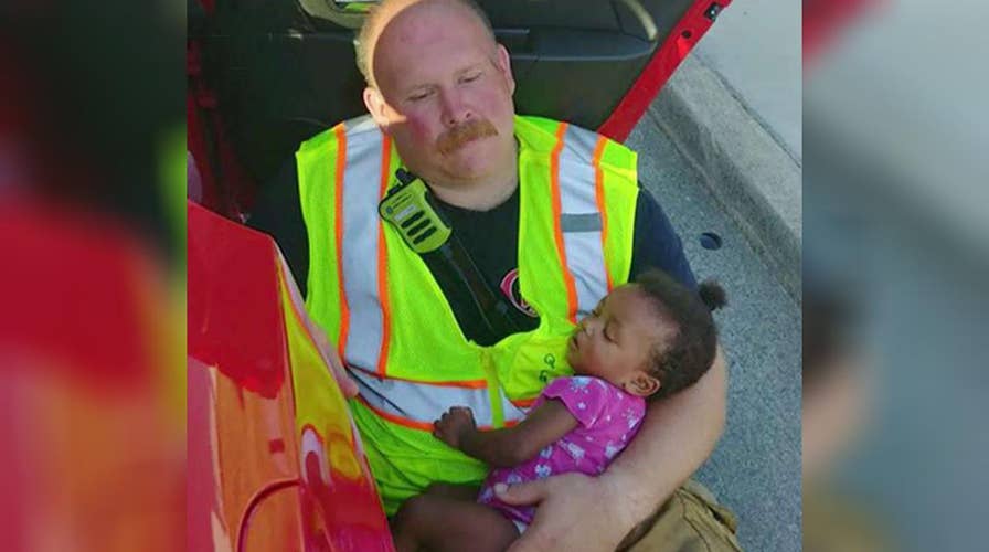 Firefighter cradling baby after car accident goes viral