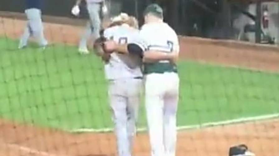 High school pitcher consoles friend after striking him out