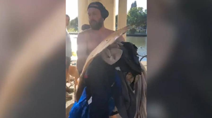Jogger throws homeless man's belongings into lake, trash