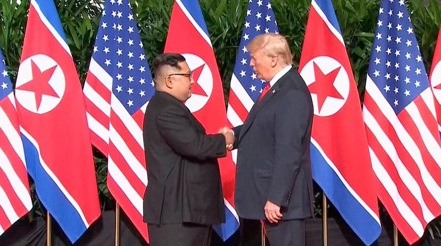 President Trump and Kim shake hands on landmark agreement