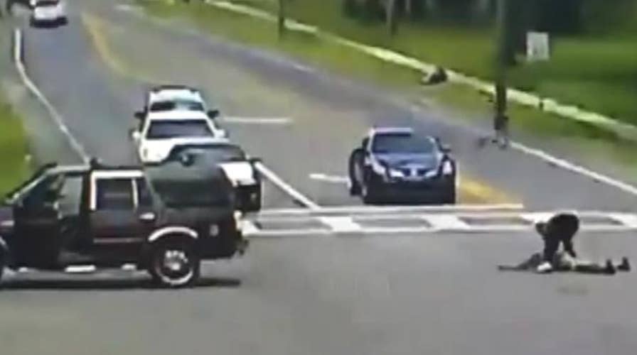 Warning, graphic content: Woman falls out of moving SUV