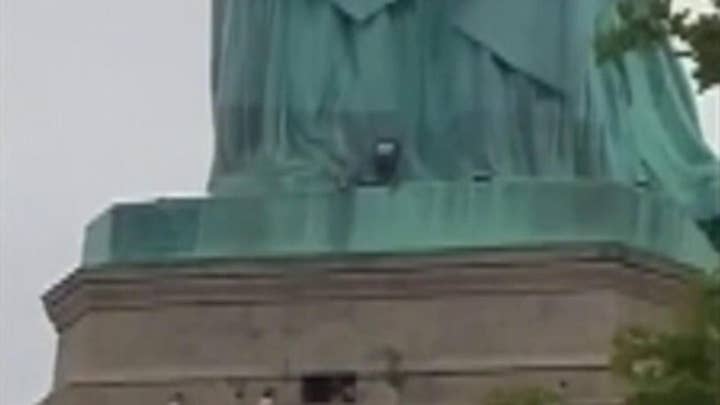 Raw Video: Protestor caught climbing the Statue of Liberty