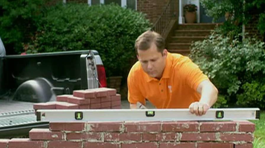 Republican congressional candidate builds wall in new ad