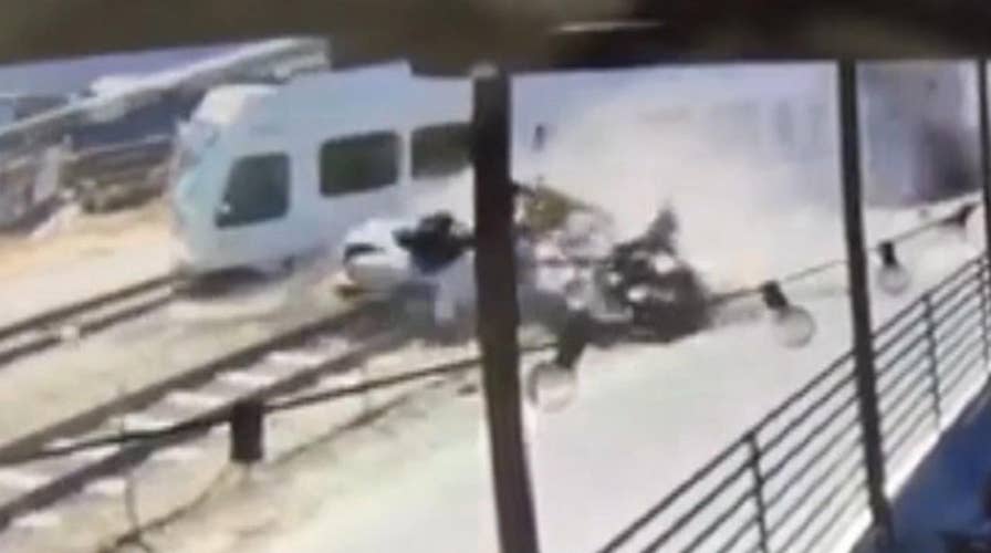 Deadly collision between car and train caught on camera