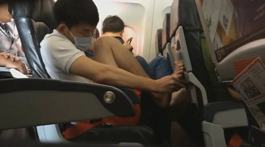 Gross video: Plane passenger caught picking toe nails