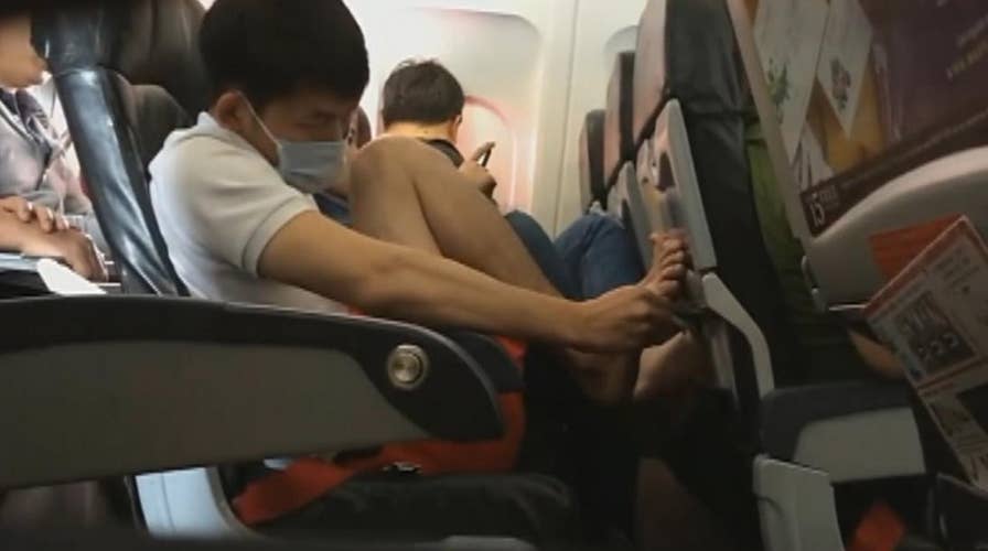 Gross video: Plane passenger caught picking toe nails