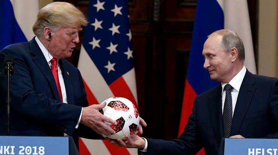 Soccer diplomacy? Putin passes World Cup ball to Trump