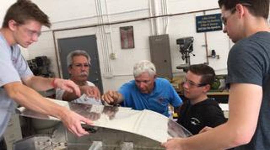 Pilots teaching students how to build an airplane