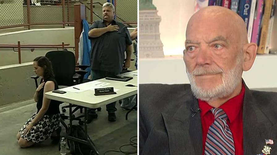 Outraged veteran slams official who knelt for pledge