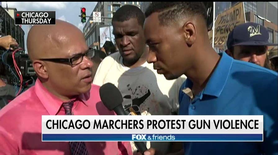 Gianno Caldwell talks to marchers calling for Rahm Emanuel's ouster.