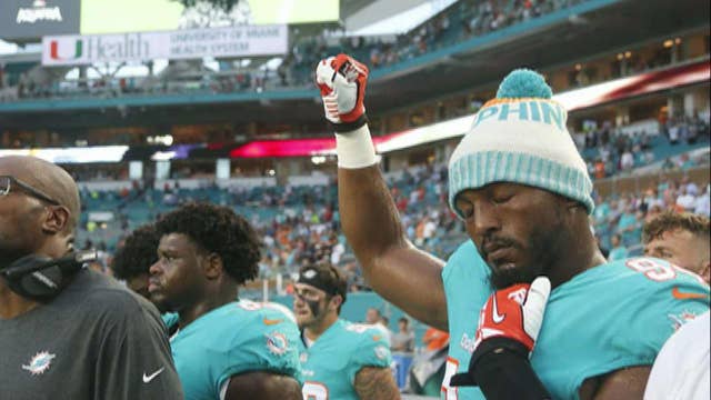 NFL players kneel, raise fists during anthem