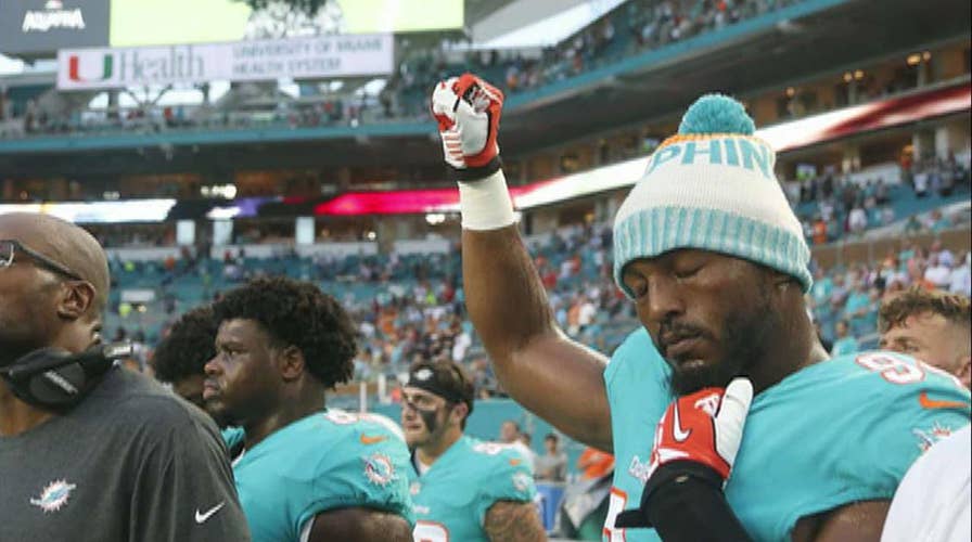 NFL players kneel, raise fists during anthem