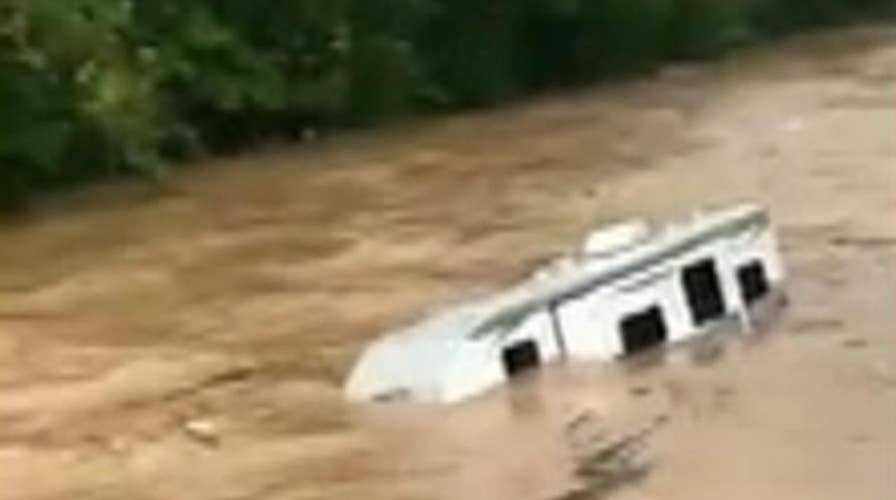 Raw video: Flood waters wash cars away downriver 