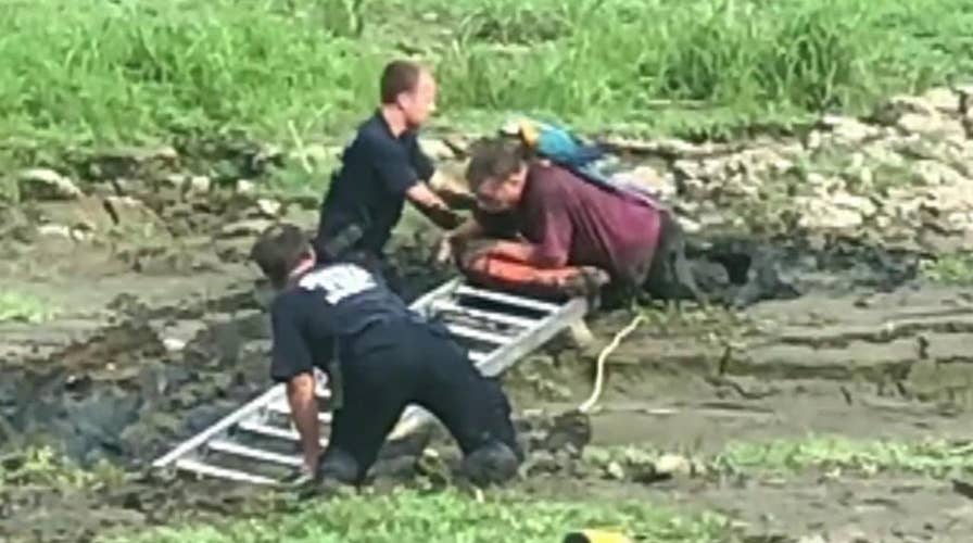 Man with parrot on his shoulder rescued from mud