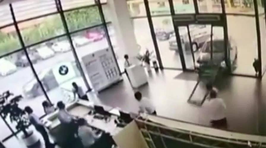 Customer returns BMW by crashing into car dealership